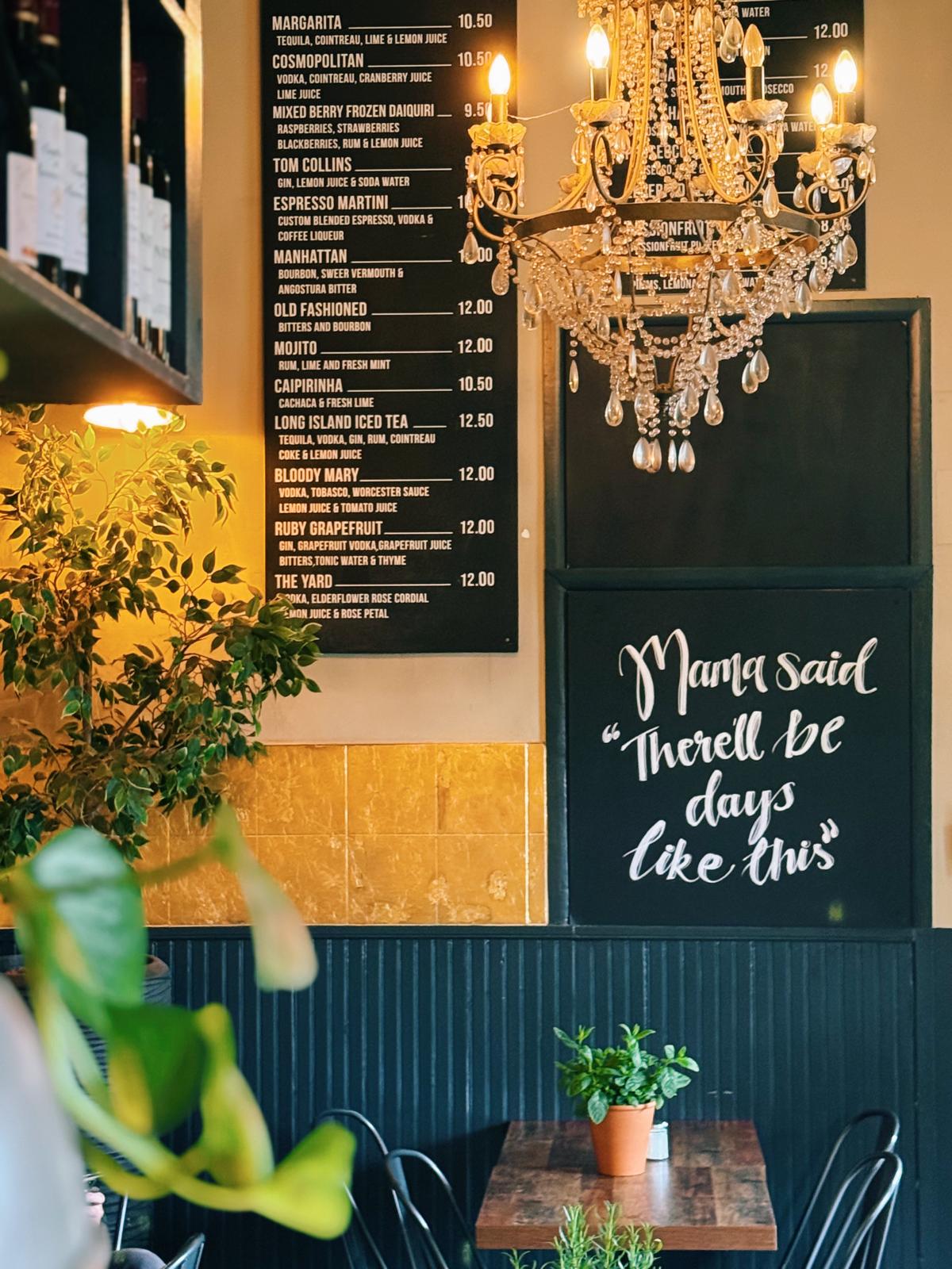 Stylish interior of The Yard Café Palmers Green with wooden tables, chairs and counter service