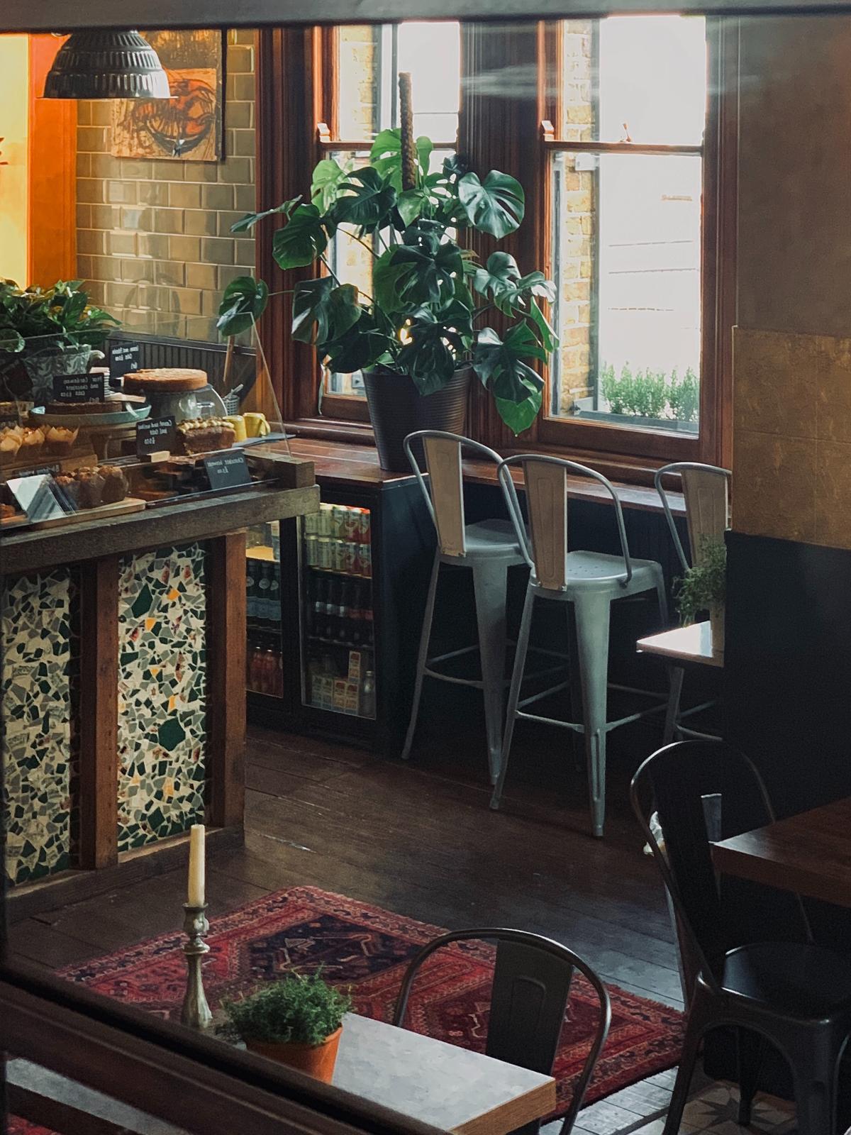 Cozy evening ambiance at The Yard Café Palmers Green with subtle lighting and wine bar setup