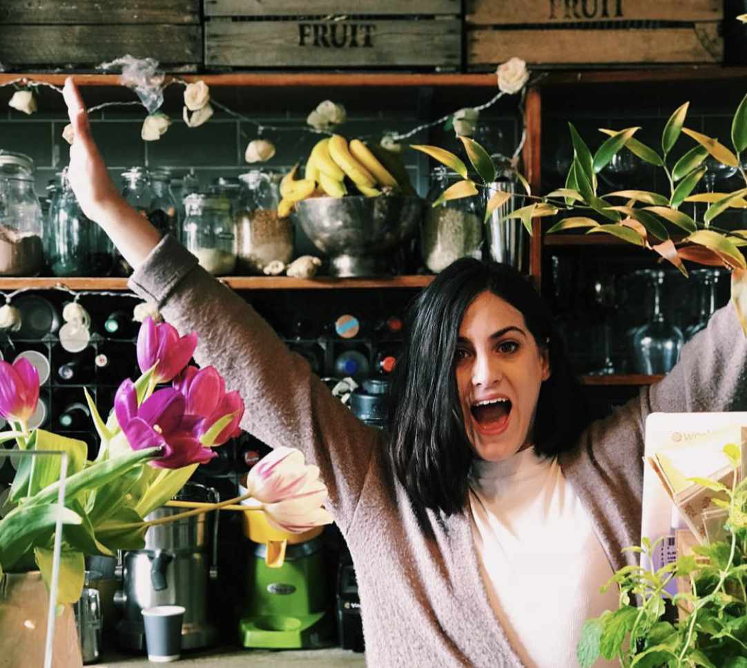 The Yard Café founder serving coffee with a warm smile at the Alexandra Palace location