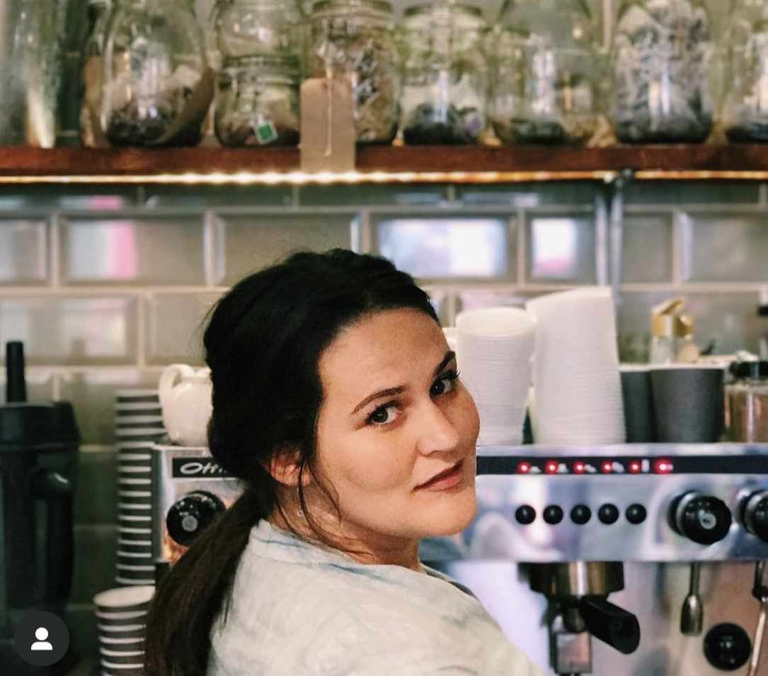 Dedicated staff member at The Yard Café taking customer orders with attention to detail